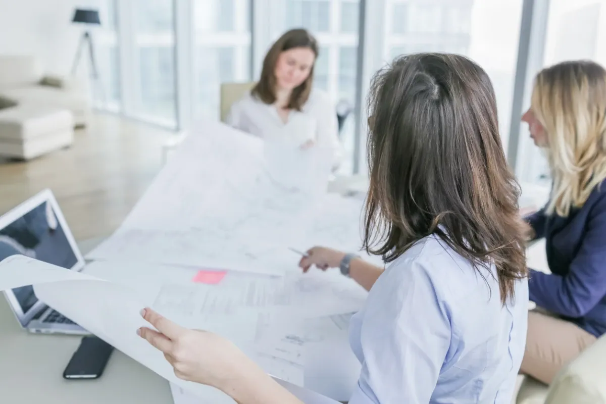 Women looking at engineering blueprints.